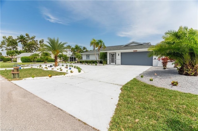 single story home featuring a garage and a front yard