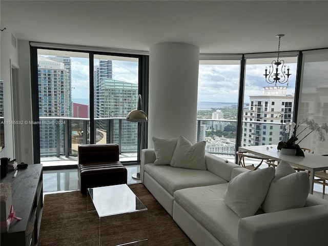 living room featuring floor to ceiling windows, a healthy amount of sunlight, and a notable chandelier