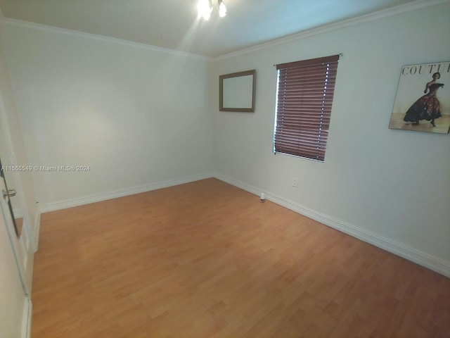 unfurnished room with ornamental molding and light hardwood / wood-style floors