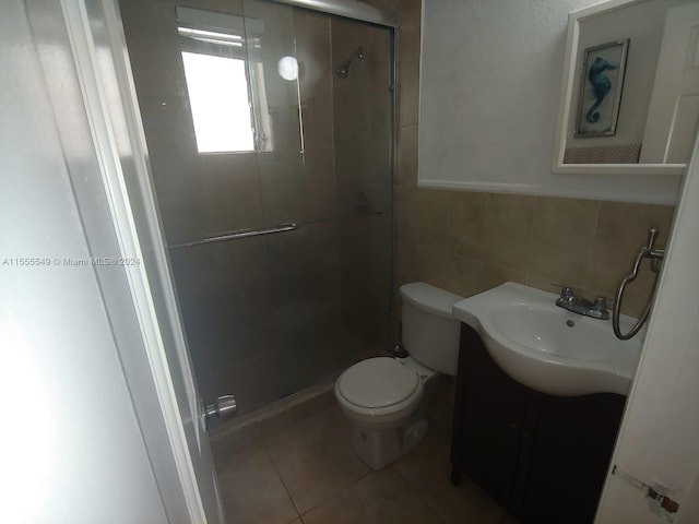 bathroom featuring tile walls, toilet, backsplash, tile floors, and vanity