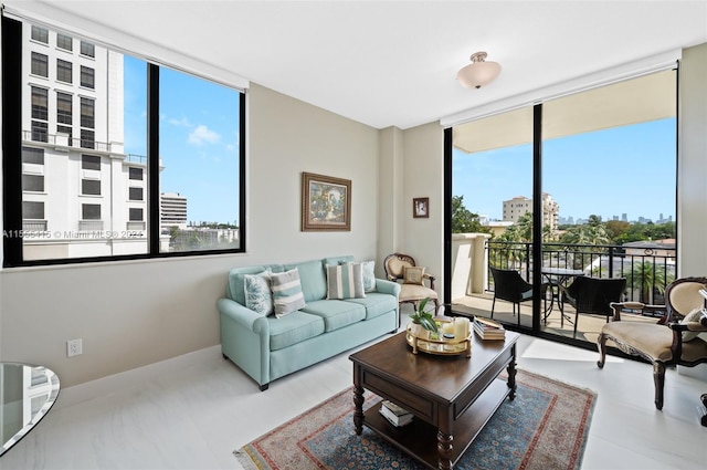 living room with a healthy amount of sunlight and a wall of windows