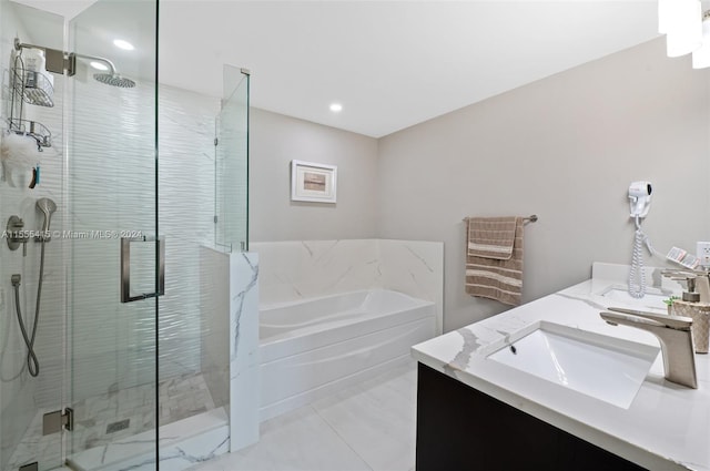 bathroom with double sink vanity, tile flooring, and separate shower and tub