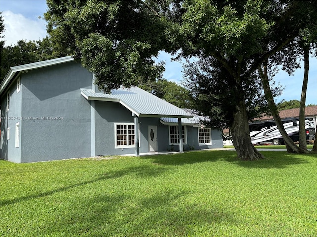 rear view of house with a yard