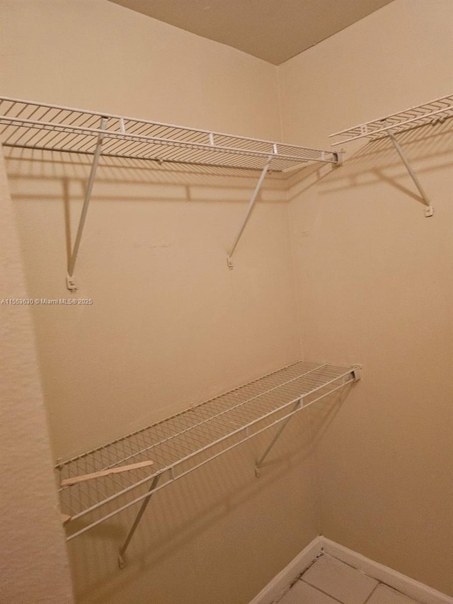 spacious closet featuring tile patterned floors