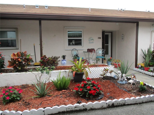 view of exterior entry featuring covered porch