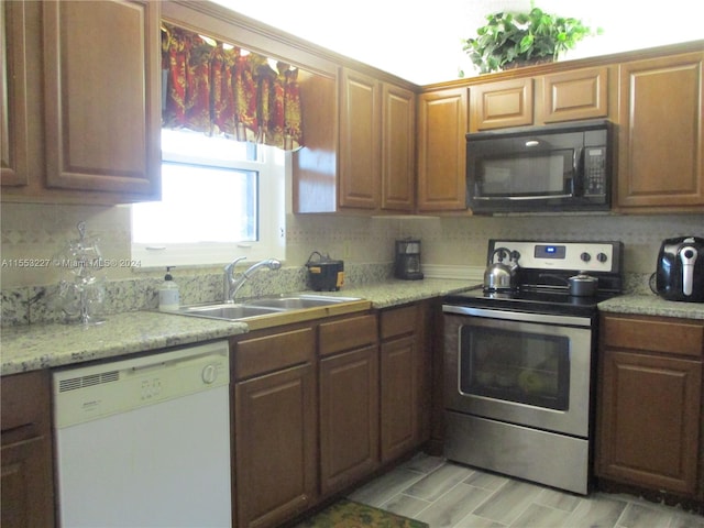 kitchen with white dishwasher, decorative backsplash, stainless steel electric range oven, and sink