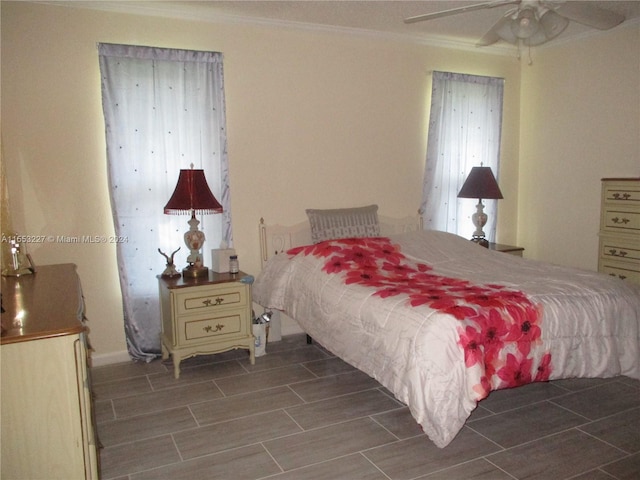 bedroom with ceiling fan and ornamental molding