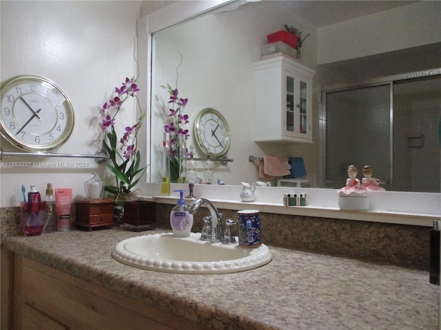 bathroom featuring vanity and a shower with door