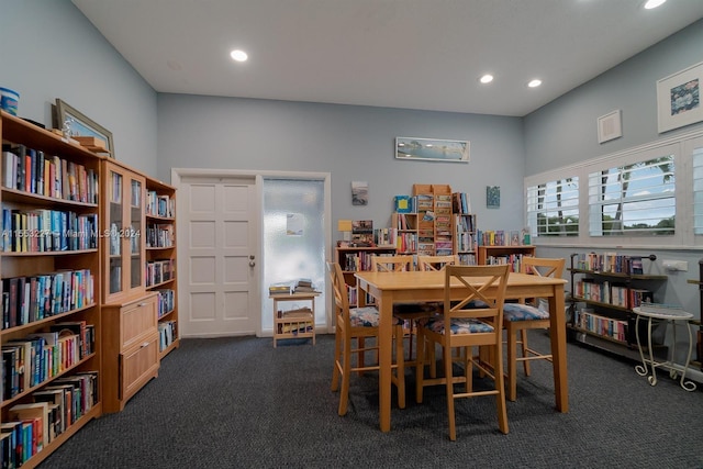 dining space featuring dark colored carpet