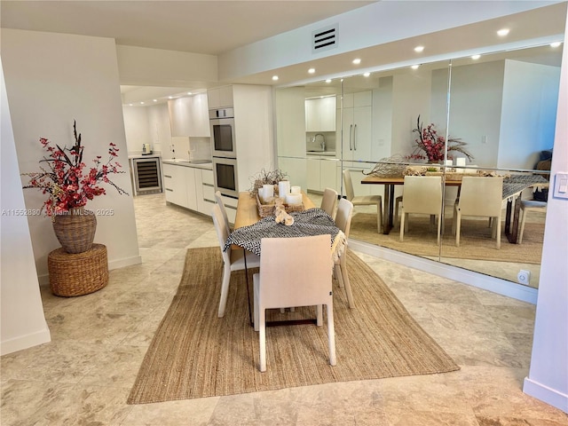 dining room with sink and beverage cooler