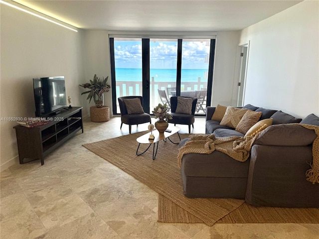 living room with a wall of windows and a water view