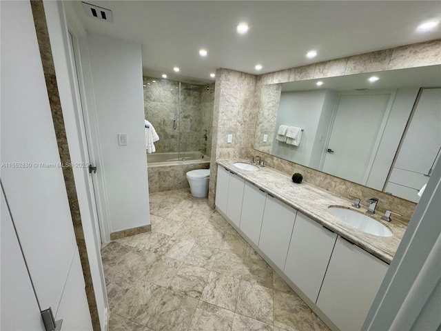 full bathroom featuring shower / bath combination with glass door, vanity, and toilet