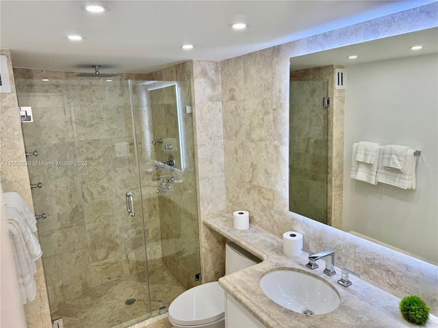 bathroom featuring toilet, walk in shower, and vanity