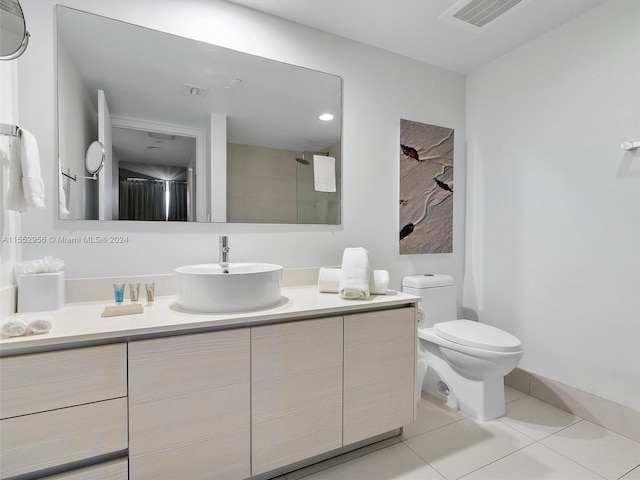 bathroom with vanity, tile floors, and toilet