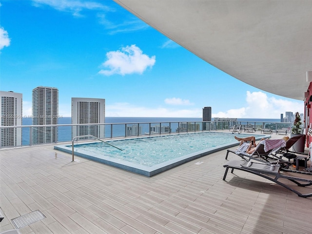 view of pool featuring a water view