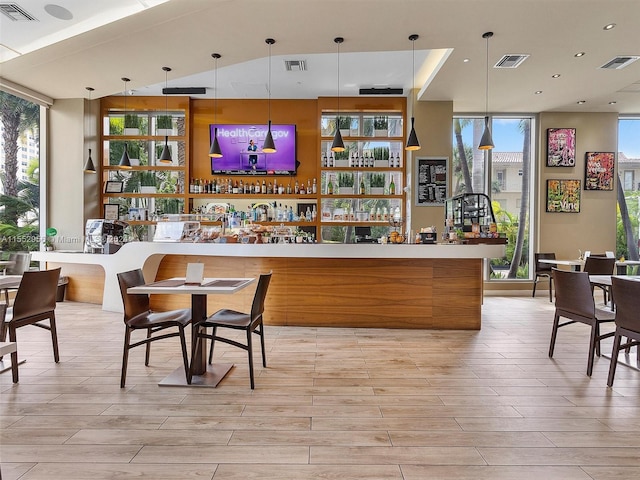 bar with expansive windows and pendant lighting