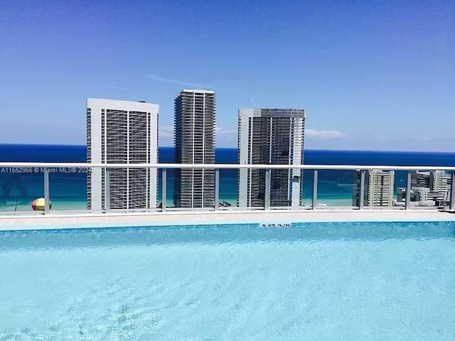 view of pool featuring a water view