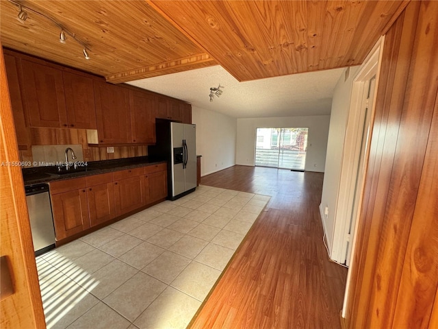 kitchen with light hardwood / wood-style flooring, stainless steel appliances, track lighting, sink, and wooden ceiling