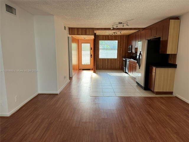 kitchen featuring light hardwood / wood-style floors, a textured ceiling, and track lighting