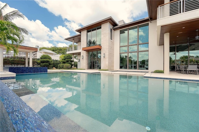 view of pool with ceiling fan and a patio area