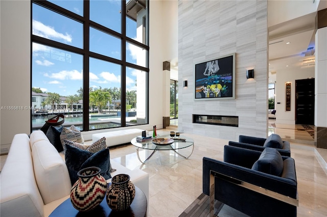 living room featuring a fireplace and a water view