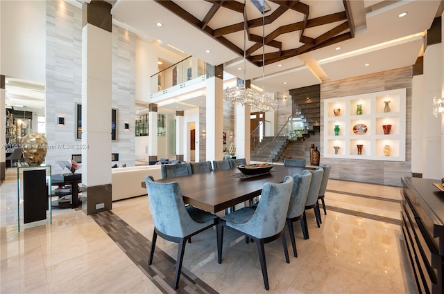 dining area with beamed ceiling, light tile patterned floors, built in shelves, a chandelier, and a towering ceiling