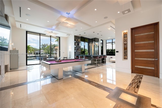 interior space featuring light tile patterned flooring, floor to ceiling windows, and pool table