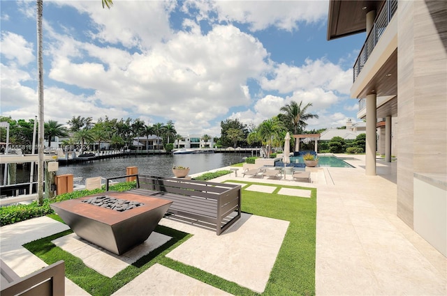 view of patio / terrace featuring a pergola, an outdoor fire pit, and a water view