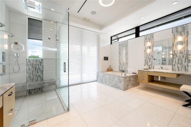 bathroom with separate shower and tub, tile patterned floors, and vanity