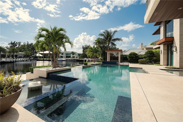 view of pool with a water view, a patio area, and an outdoor hot tub