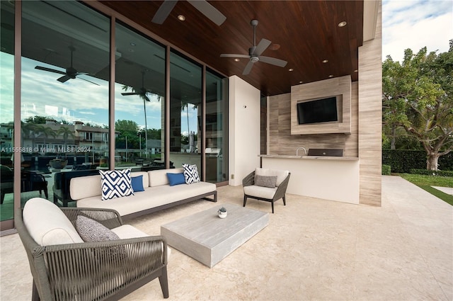 view of patio / terrace featuring grilling area, an outdoor living space, and ceiling fan