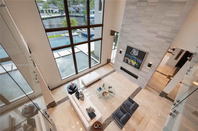 tiled living room with tile walls and a high ceiling