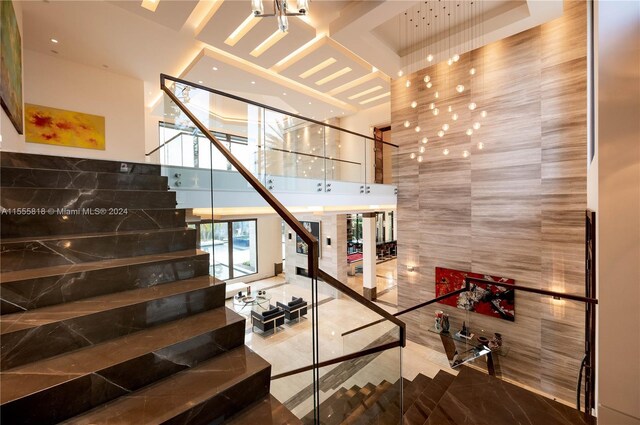 stairs featuring tile patterned flooring and tile walls