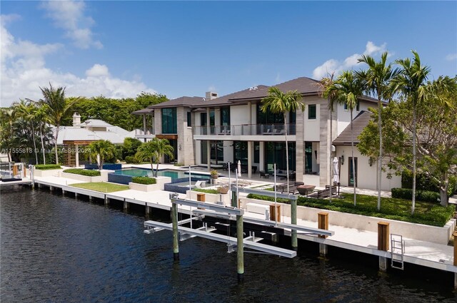 view of dock with a patio, a balcony, and a water view