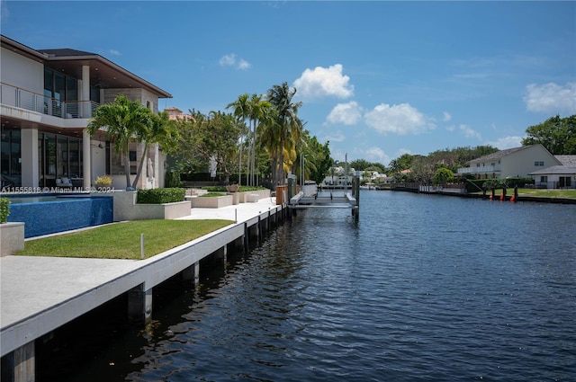 dock area with a water view and a yard