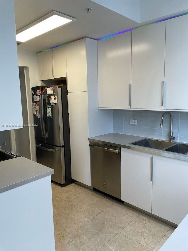 801 Brickell Key Blvd Unit 1610, Miami, FL 33131 - kitchen featuring appliances with stainless steel finishes, tasteful backsplash, and white cabinets