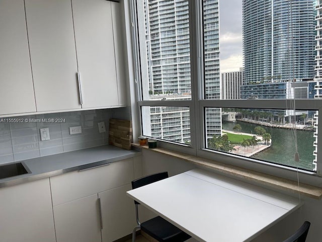 801 Brickell Key Blvd Unit 1610, Miami, FL 33131 - kitchen featuring decorative backsplash, healthy amount of natural light, white cabinetry, and light countertops