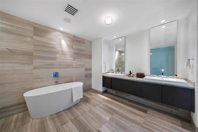 bathroom featuring tile walls, tile patterned flooring, and shower with separate bathtub