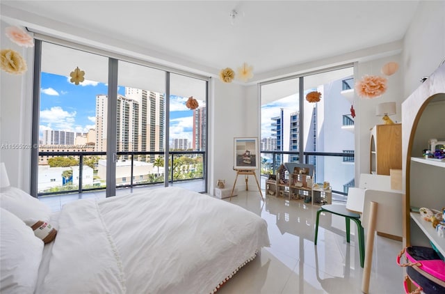 tiled bedroom featuring expansive windows and multiple windows