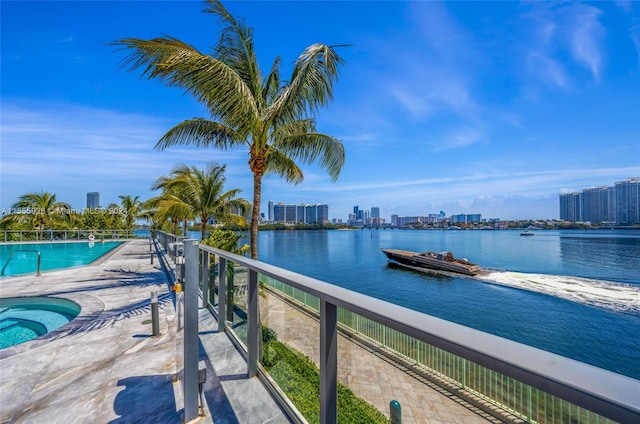 exterior space with a community pool and a water view