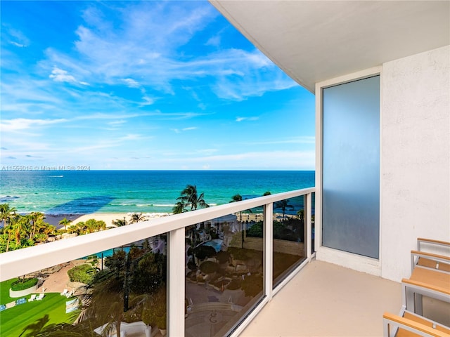 balcony with a view of the beach and a water view