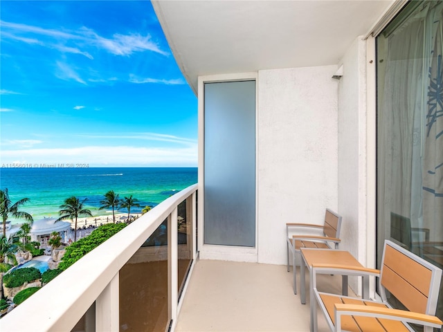 balcony with a beach view and a water view