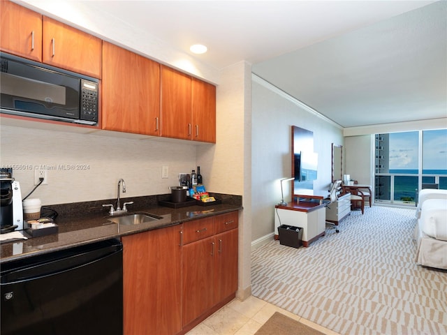 kitchen with crown molding, black appliances, sink, and dark stone counters