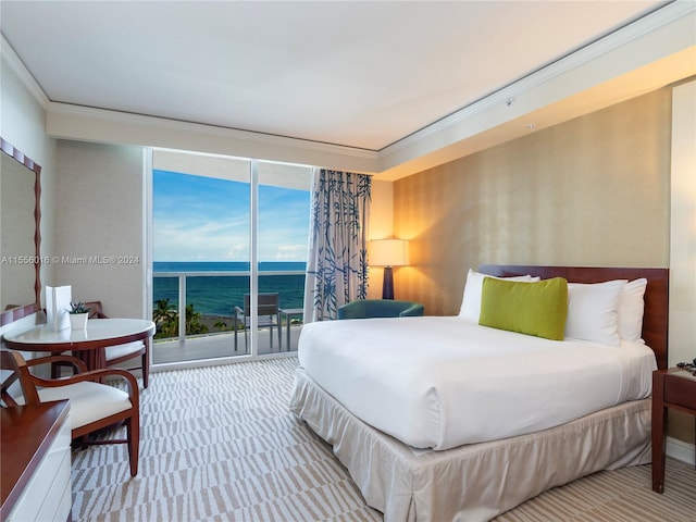 carpeted bedroom featuring crown molding, a water view, and access to outside