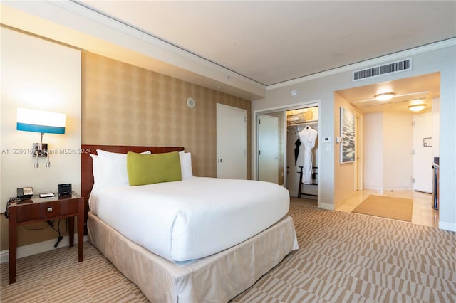 bedroom featuring crown molding, a spacious closet, and a closet