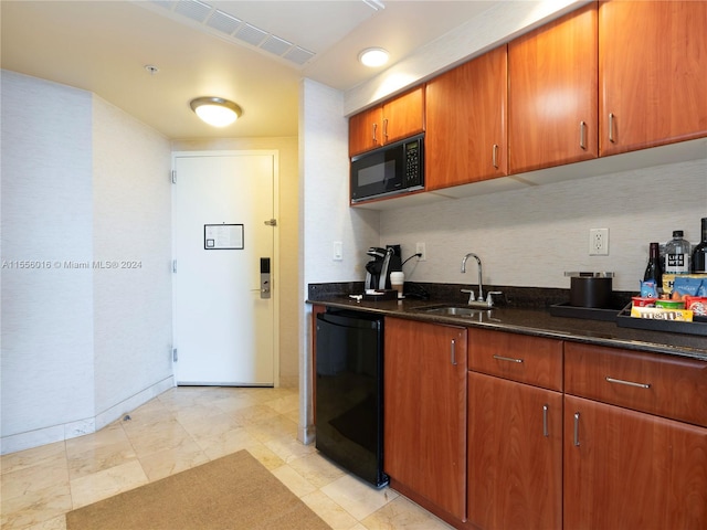 kitchen with black appliances, dark stone countertops, and sink