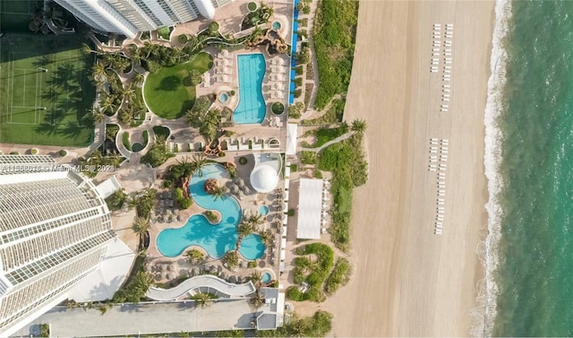 drone / aerial view with a beach view and a water view