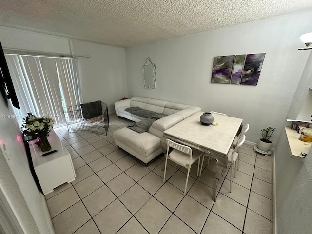 living room with a textured ceiling and light tile floors