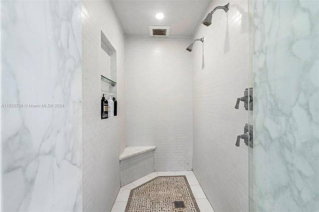 bathroom featuring tiled shower and tile patterned flooring