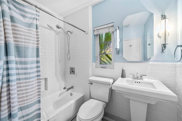 bathroom featuring tile walls, toilet, decorative backsplash, and shower / bath combo with shower curtain